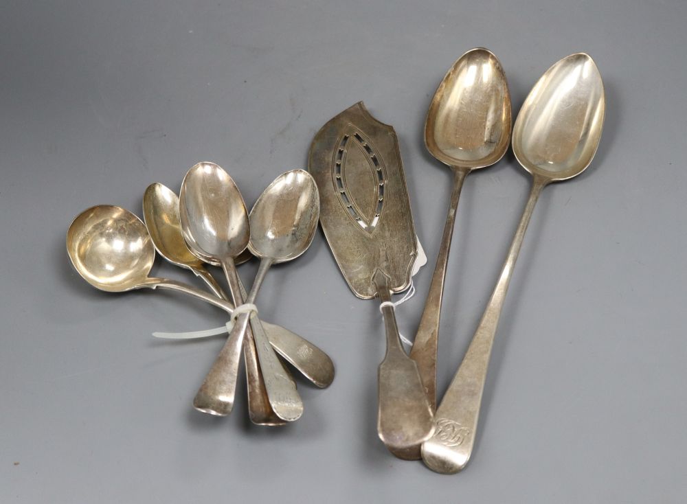 A group of Georgian silver serving spoons, tablespoons and a fish slice